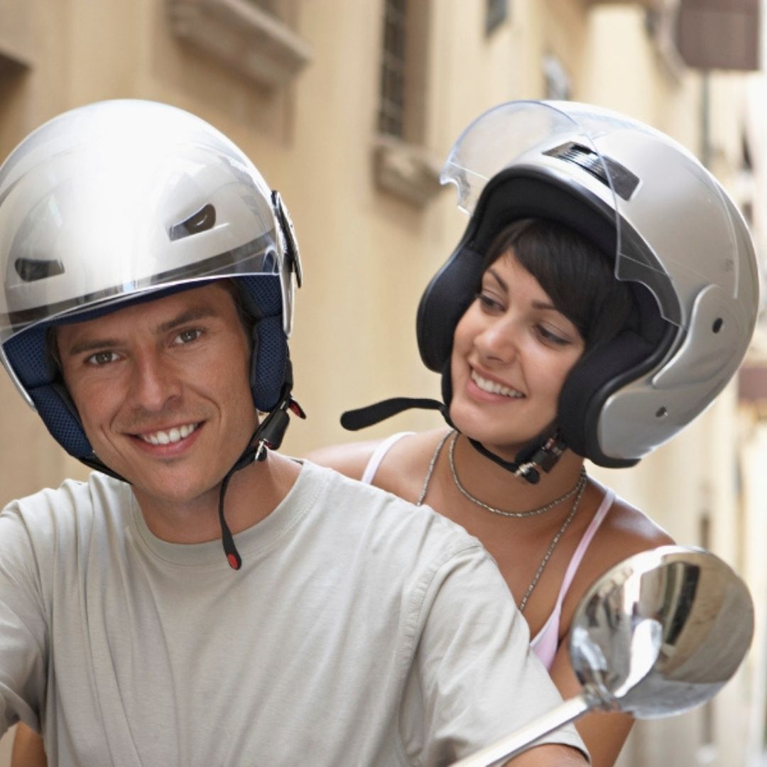 a couple riding a scooter together