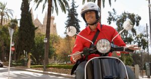 a man driving a scooter