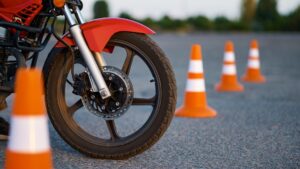 Scooter wheel in between cones.